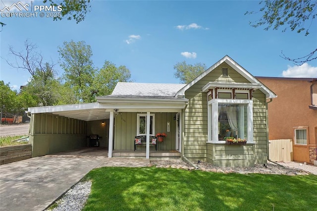2144 Glenn St, Colorado Springs, CO 80904 - view of front of home with driveway, board and batten siding, a porch, and a front lawn