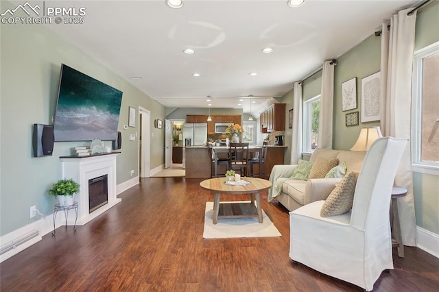 2144 Glenn St, Colorado Springs, CO 80904 - living room featuring recessed lighting, dark wood-style flooring, a glass covered fireplace, and baseboards