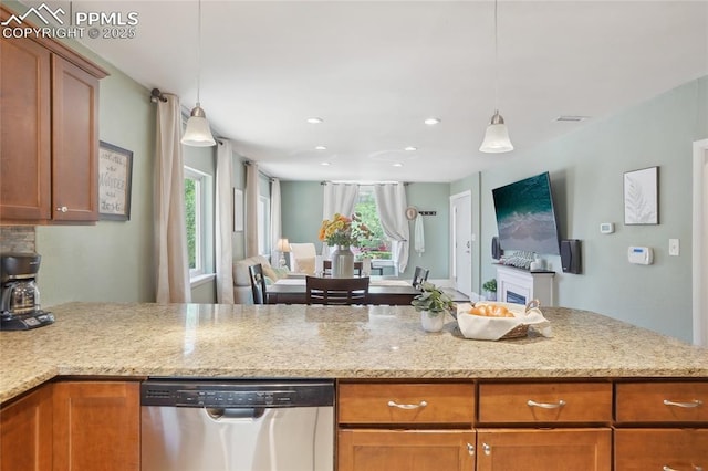 2144 Glenn St, Colorado Springs, CO 80904 - kitchen with stainless steel dishwasher, open floor plan, recessed lighting, hanging light fixtures, and brown cabinets