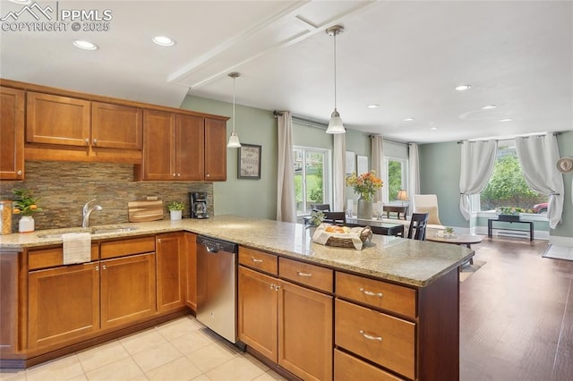 2144 Glenn St, Colorado Springs, CO 80904 - kitchen featuring stainless steel dishwasher, a peninsula, brown cabinetry, tasteful backsplash, and recessed lighting