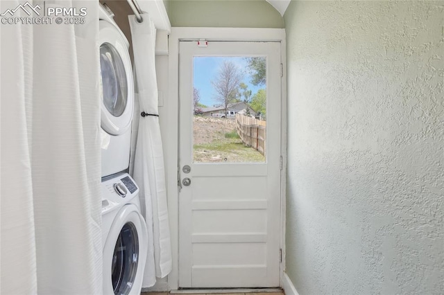2144 Glenn St, Colorado Springs, CO 80904 - laundry room with estacked washer and dryer, a textured wall, and baseboards