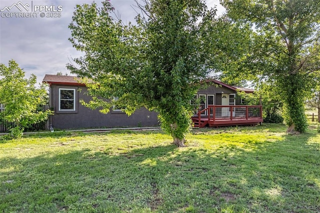 17155 Sagecreek Rd, Peyton, CO 80831 - rear view of property with a wooden deck, a yard, and stucco siding
