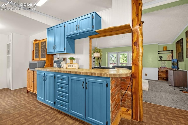17155 Sagecreek Rd, Peyton, CO 80831 - kitchen featuring blue cabinetry, light countertops, and open floor plan