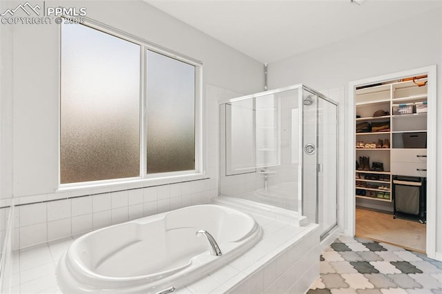 10211 Murmuring Pine Ct, Colorado Springs, CO 80920 - bathroom with a shower stall, a garden tub, and a walk in closet