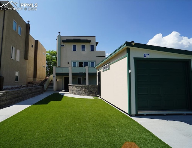 1407 Manitou Blvd, Colorado Springs, CO 80904 - view of front of house featuring stucco siding, a front yard, stairway, a balcony, and an attached garage