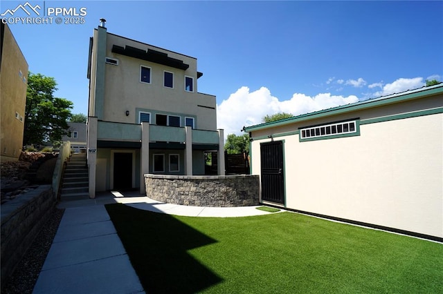 1407 Manitou Blvd, Colorado Springs, CO 80904 - back of house with stairs, stucco siding, and a yard