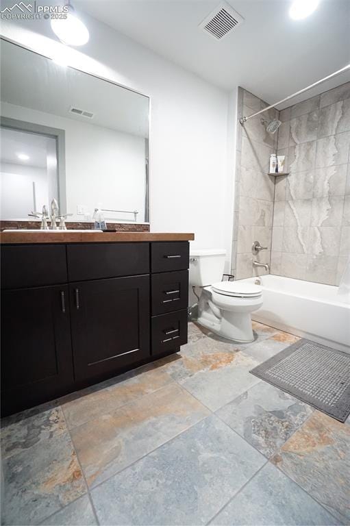 1407 Manitou Blvd, Colorado Springs, CO 80904 - full bathroom with vanity, shower / bathtub combination, and stone tile floors