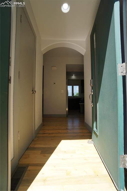 1407 Manitou Blvd, Colorado Springs, CO 80904 - hallway featuring arched walkways, wood finished floors, and recessed lighting