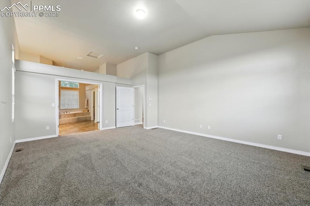 13080 Mt Harvard Dr, Peyton, CO 80831 - unfurnished bedroom featuring lofted ceiling, carpet floors, and ensuite bath