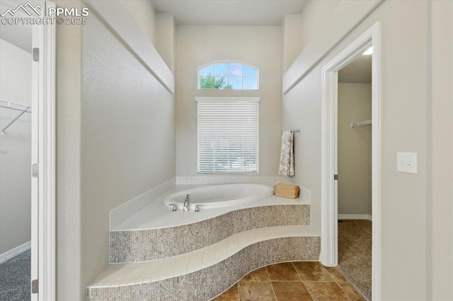 13080 Mt Harvard Dr, Peyton, CO 80831 - bathroom with a bath and a spacious closet
