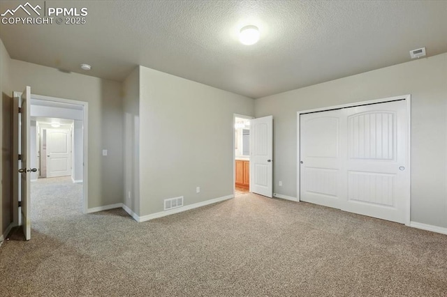 13080 Mt Harvard Dr, Peyton, CO 80831 - unfurnished bedroom with carpet floors, a textured ceiling, a closet, and ensuite bathroom