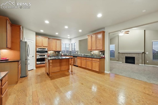 13080 Mt Harvard Dr, Peyton, CO 80831 - kitchen featuring open floor plan, dark countertops, recessed lighting, a center island, and light wood-style flooring