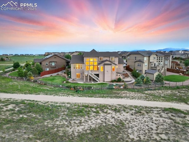 13080 Mt Harvard Dr, Peyton, CO 80831 - view of front facade with a fenced backyard, stairway, stucco siding, and a residential view