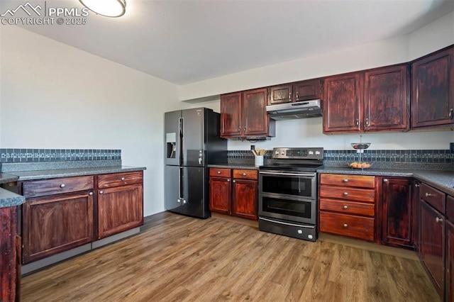 2852 Front Royal Dr, Colorado Springs, CO 80919 - kitchen featuring double oven range, fridge with ice dispenser, under cabinet range hood, and wood finished floors