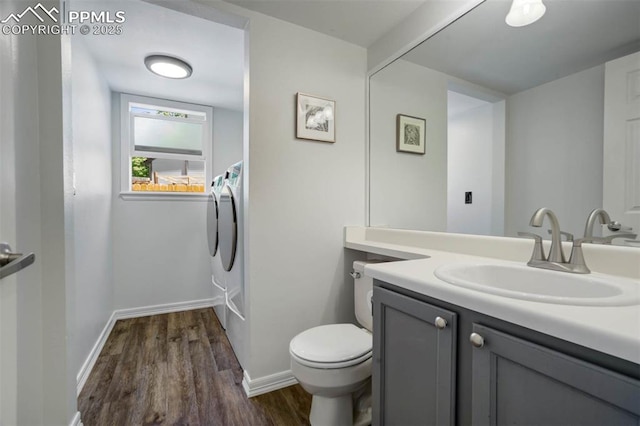 2852 Front Royal Dr, Colorado Springs, CO 80919 - bathroom featuring washing machine and clothes dryer, wood finished floors, and vanity