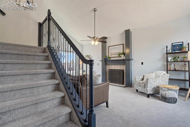 2852 Front Royal Dr, Colorado Springs, CO 80919 - stairs featuring carpet, ceiling fan, a tile fireplace, and a textured ceiling