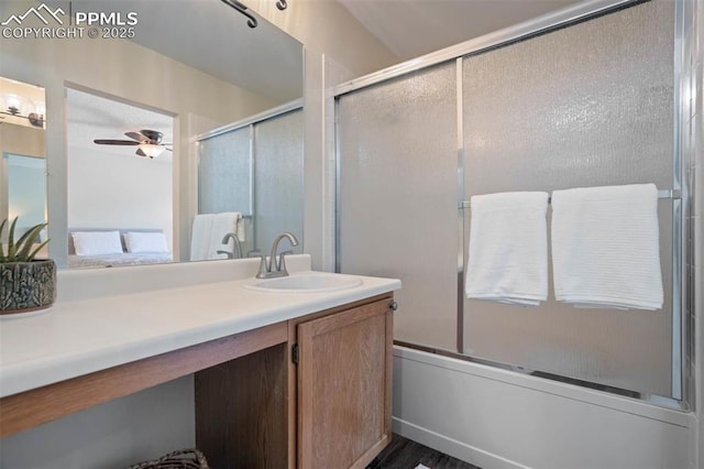 2852 Front Royal Dr, Colorado Springs, CO 80919 - bathroom featuring vanity, bath / shower combo with glass door, a ceiling fan, and wood finished floors