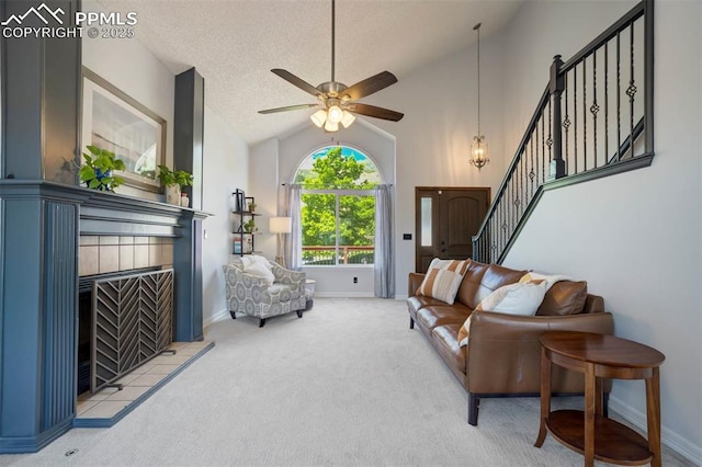 2852 Front Royal Dr, Colorado Springs, CO 80919 - carpeted living room with stairs, a fireplace, ceiling fan, lofted ceiling, and a textured ceiling