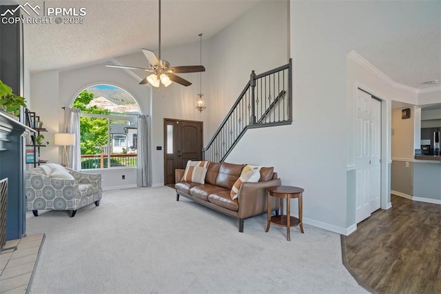 2852 Front Royal Dr, Colorado Springs, CO 80919 - living room with a textured ceiling, ceiling fan, lofted ceiling, carpet floors, and stairs