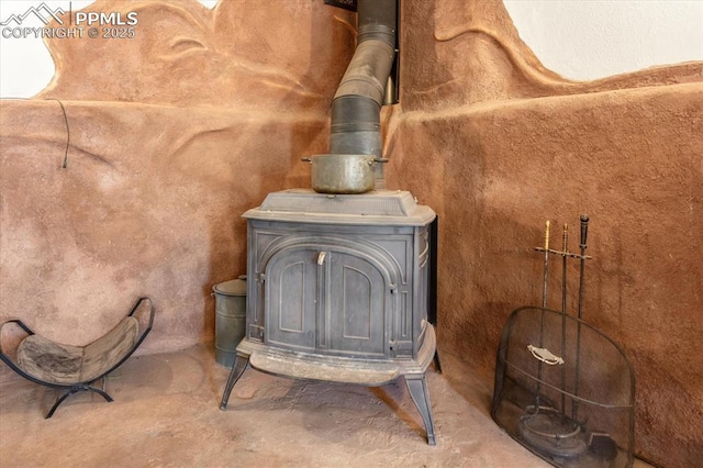 125 1st St, Saguache, CO 81149 - detailed view of a wood stove and unfinished concrete flooring