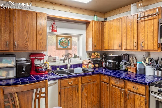 125 1st St, Saguache, CO 81149 - kitchen featuring brown cabinets and tile countertops