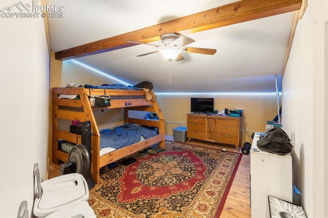 125 1st St, Saguache, CO 81149 - bedroom featuring beam ceiling, wood finished floors, and a ceiling fan
