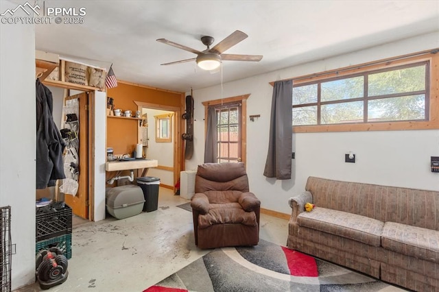 125 1st St, Saguache, CO 81149 - living area with concrete flooring and a ceiling fan