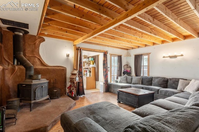 125 1st St, Saguache, CO 81149 - living area with a wood stove, a wood ceiling with exposed beams, and wood finished floors