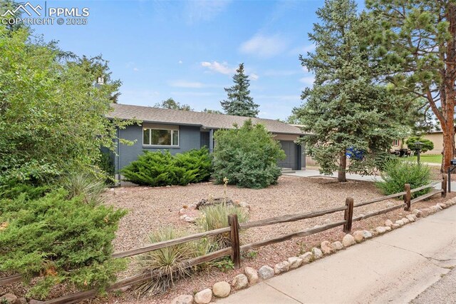 110 Fordham St, Colorado Springs, CO 80911 - view of front facade featuring a garage, concrete driveway, and roof with shingles