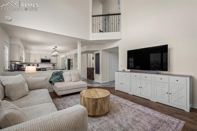 2570 Wimbleton Ct, Colorado Springs, CO 80920 - living area with a chandelier and dark wood-type flooring