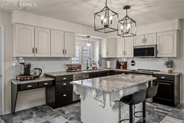 2570 Wimbleton Ct, Colorado Springs, CO 80920 - kitchen with appliances with stainless steel finishes, white cabinetry, light stone countertops, and tasteful backsplash
