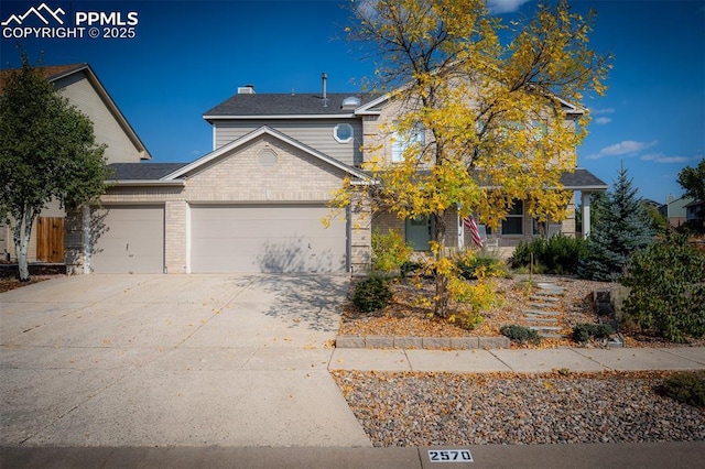 2570 Wimbleton Ct, Colorado Springs, CO 80920 - view of front of house featuring a garage, driveway, and brick siding