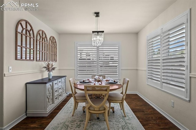 2570 Wimbleton Ct, Colorado Springs, CO 80920 - dining area featuring a chandelier and dark wood-style floors