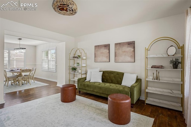 2570 Wimbleton Ct, Colorado Springs, CO 80920 - living area with dark wood-style flooring and a chandelier