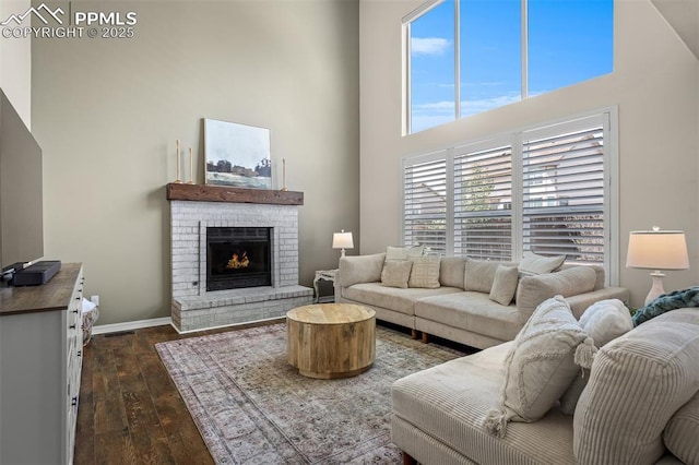 2570 Wimbleton Ct, Colorado Springs, CO 80920 - living room featuring a towering ceiling, dark wood-style flooring, and a fireplace