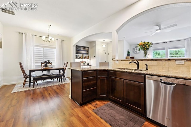 1914 Birmingham Loop, Colorado Springs, CO 80910 - kitchen with dishwasher, arched walkways, tasteful backsplash, and a chandelier