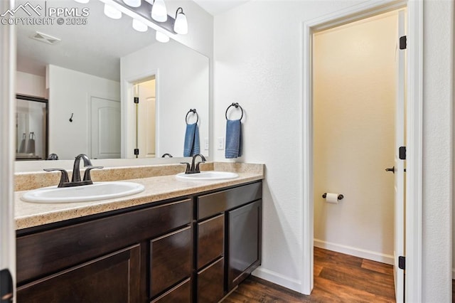 1914 Birmingham Loop, Colorado Springs, CO 80910 - full bathroom with double vanity and wood finished floors
