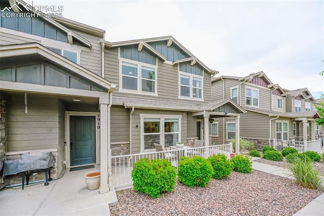 1914 Birmingham Loop, Colorado Springs, CO 80910 - view of front of home featuring board and batten siding, stone siding, and a residential view