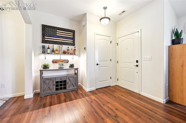 1914 Birmingham Loop, Colorado Springs, CO 80910 - foyer entrance with wood finished floors and a dry bar