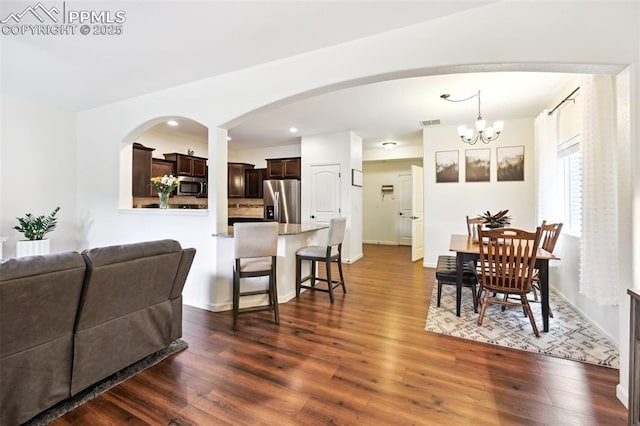 1914 Birmingham Loop, Colorado Springs, CO 80910 - dining room featuring a chandelier, dark wood-style floors, arched walkways, and recessed lighting