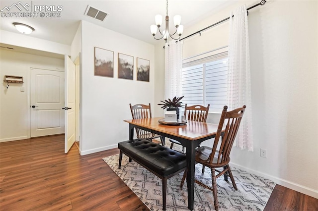 1914 Birmingham Loop, Colorado Springs, CO 80910 - dining space with a chandelier and dark wood-style flooring