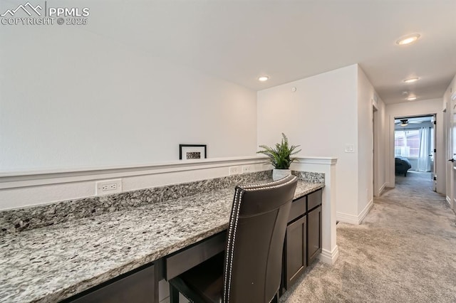 1851 Spring Water Pt, Colorado Springs, CO 80908 - kitchen with light carpet, light stone counters, and recessed lighting