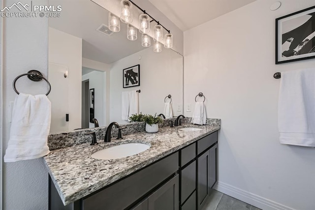 1851 Spring Water Pt, Colorado Springs, CO 80908 - full bathroom featuring double vanity and baseboards