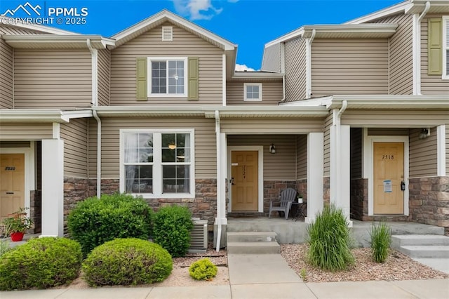 7524 Sandy Springs Pt, Fountain, CO 80817 - view of front facade featuring a porch and stone siding