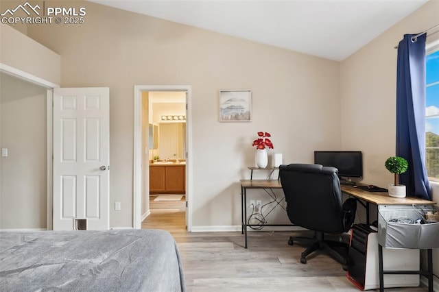 7524 Sandy Springs Pt, Fountain, CO 80817 - bedroom with wood finished floors, lofted ceiling, an office area, and ensuite bathroom