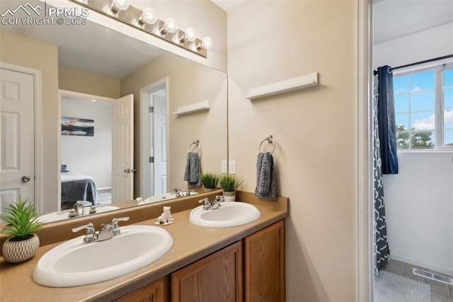 7524 Sandy Springs Pt, Fountain, CO 80817 - bathroom with double vanity, ensuite bath, and tile patterned flooring