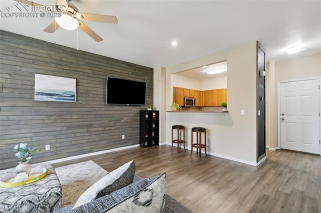 7524 Sandy Springs Pt, Fountain, CO 80817 - living room featuring a ceiling fan, wood finished floors, an accent wall, and recessed lighting
