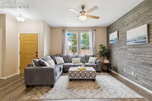 7524 Sandy Springs Pt, Fountain, CO 80817 - living area with an accent wall, wood finished floors, and ceiling fan