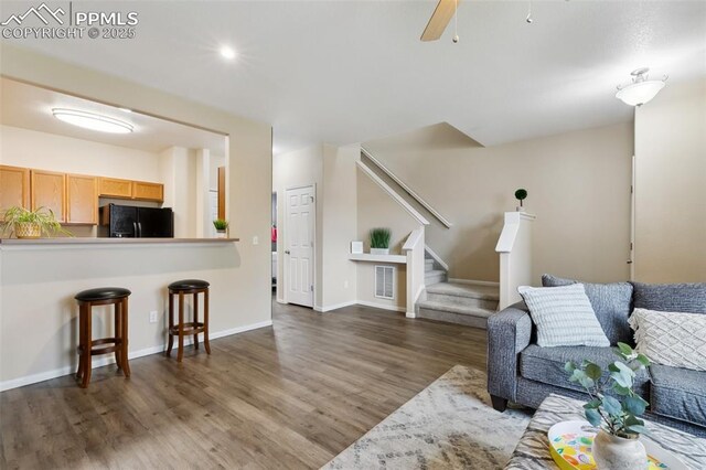 7524 Sandy Springs Pt, Fountain, CO 80817 - living area featuring wood finished floors, stairway, and a ceiling fan