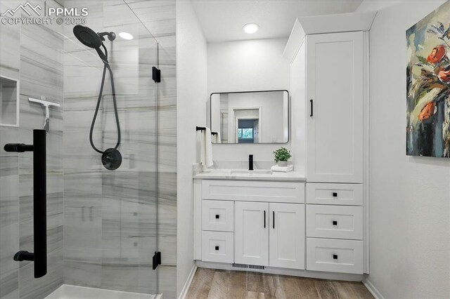 1112 Modes St, Colorado Springs, CO 80904 - bathroom featuring a shower stall, vanity, and baseboards